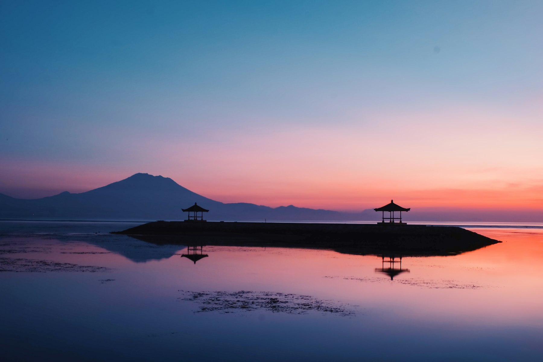Sunrise over the sea in Bali with Mount Agung in the distance